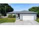 Charming single-story home with a well-manicured lawn and a two-car garage at 344 Buenaventura Blvd, Kissimmee, FL 34743