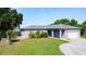 Single story home featuring a well-manicured lawn and two car garage at 344 Buenaventura Blvd, Kissimmee, FL 34743