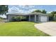 Charming single-story home featuring a well-manicured lawn and attached two-car garage at 344 Buenaventura Blvd, Kissimmee, FL 34743