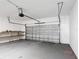 Spacious garage with gray floor, overhead door, and block walls at 344 Buenaventura Blvd, Kissimmee, FL 34743