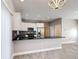 Bright kitchen featuring stainless steel appliances and dark countertops at 344 Buenaventura Blvd, Kissimmee, FL 34743