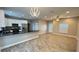 Sunlit living area featuring an open floor plan, modern lighting, and wood-look tile at 344 Buenaventura Blvd, Kissimmee, FL 34743