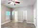Spacious main bedroom featuring a ceiling fan, wood-look floors, and ensuite bath at 344 Buenaventura Blvd, Kissimmee, FL 34743