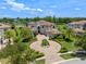 Stunning aerial view of a luxurious home with a circular driveway, mature trees, and lush landscaping at 4071 Isabella Cir, Windermere, FL 34786