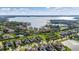 Aerial view of luxurious homes near a large lake, surrounded by lush greenery and mature trees at 4071 Isabella Cir, Windermere, FL 34786