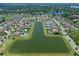Aerial view of homes surrounding a lake, featuring lush landscaping and serene water views at 4071 Isabella Cir, Windermere, FL 34786