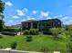 Expansive backyard featuring lush green lawn, mature landscaping, and a screened-in pool enclosure at 4071 Isabella Cir, Windermere, FL 34786