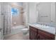 Bright bathroom features marble vanity, tile shower and tub, and a single window at 4071 Isabella Cir, Windermere, FL 34786