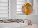 Bright bathroom with marble counters, mosaic backsplash, and yellow flower in a decorative vase at 4071 Isabella Cir, Windermere, FL 34786