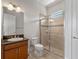Bathroom featuring granite counters, a glass shower, and tiled floors at 4071 Isabella Cir, Windermere, FL 34786