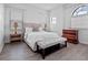 Bright bedroom with hardwood floors, a white bed, neutral decor, and many windows at 4071 Isabella Cir, Windermere, FL 34786