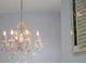 Ornate crystal chandelier in a foyer provides classic elegance to this traditional home at 4071 Isabella Cir, Windermere, FL 34786