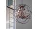 An eye-catching orb chandelier hangs from the ceiling with a large window in the background at 4071 Isabella Cir, Windermere, FL 34786