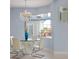 Cozy dining area with a glass table, modern chairs, chandelier, and bright natural light at 4071 Isabella Cir, Windermere, FL 34786