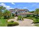 Stately luxury home boasts professional landscaping, circular driveway, and a tile roof at 4071 Isabella Cir, Windermere, FL 34786