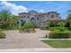 Luxury home boasts professional landscaping, circular driveway, and an attached three-car garage at 4071 Isabella Cir, Windermere, FL 34786