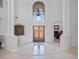 Bright, luxury home foyer boasts soaring ceilings, decorative tile flooring, and an ornate chandelier at 4071 Isabella Cir, Windermere, FL 34786