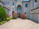 Luxury home features a grand entrance with a brick driveway and manicured flowerbeds at 4071 Isabella Cir, Windermere, FL 34786