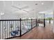 Upstairs hallway with high ceilings overlooking the foyer, pool and backyard at 4071 Isabella Cir, Windermere, FL 34786