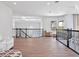 Upstairs hallway with a loft, hardwood floors, and a view of the backyard at 4071 Isabella Cir, Windermere, FL 34786
