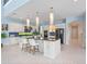 Spacious kitchen with a center island, granite counters, stainless steel appliances, and stylish pendant lights at 4071 Isabella Cir, Windermere, FL 34786