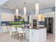 Large kitchen with island, stainless appliances, and decorative lighting, perfect for entertaining at 4071 Isabella Cir, Windermere, FL 34786