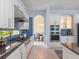 Open kitchen design with stainless steel appliances, granite countertops, and archway leading to dining area at 4071 Isabella Cir, Windermere, FL 34786
