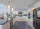 Bright, spacious kitchen with a dark countertop island, stainless steel appliances, and elegant chandelier lighting at 4071 Isabella Cir, Windermere, FL 34786