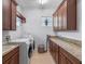 Convenient laundry room with washer, dryer, storage cabinets, and granite countertops at 4071 Isabella Cir, Windermere, FL 34786