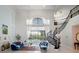 Bright, luxury living room features high ceilings, spiral staircase, and backyard pool views at 4071 Isabella Cir, Windermere, FL 34786