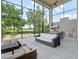 Relaxing living room offers an outdoor kitchen and features floor-to-ceiling glass windows overlooking the landscape at 4071 Isabella Cir, Windermere, FL 34786