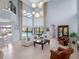 Bright and airy living room with a view of the pool and soaring ceilings at 4071 Isabella Cir, Windermere, FL 34786