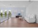 Upstairs loft area with seating, a TV, wood floors, and a backyard view at 4071 Isabella Cir, Windermere, FL 34786