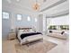Spacious main bedroom with tray ceilings, chandelier, and sitting area at 4071 Isabella Cir, Windermere, FL 34786