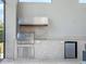 Fully equipped outdoor kitchen with granite countertops and stainless steel appliances provides cooking and entertaining at 4071 Isabella Cir, Windermere, FL 34786