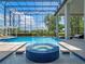 A stunning pool with a hot tub, encased with an elegant enclosure, promising year-round enjoyment and relaxation at 4071 Isabella Cir, Windermere, FL 34786