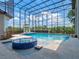Inviting pool with hot tub features a screened-in enclosure, offering an ideal space for year-round fun at 4071 Isabella Cir, Windermere, FL 34786