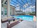 Enclosed pool area with cozy seating, includes a stylish fire pit, creating an inviting outdoor space for gatherings at 4071 Isabella Cir, Windermere, FL 34786