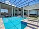 Gorgeous pool with cabana and sun loungers, features screened-in enclosure, offering a serene retreat for relaxation at 4071 Isabella Cir, Windermere, FL 34786