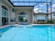 Luxury home featuring a vast swimming pool and spa, offering a serene retreat in a screened-in outdoor space at 4071 Isabella Cir, Windermere, FL 34786