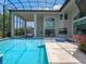 Luxury pool area showcases architecture and design, featuring a pristine pool, spa, and an open, airy enclosure at 4071 Isabella Cir, Windermere, FL 34786