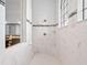 Modern shower with marble-style tile, a window, and updated fixtures at 4071 Isabella Cir, Windermere, FL 34786
