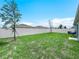 Spacious backyard is fenced in, has grass and two small trees at 440 Patricia Alford Dr, Haines City, FL 33844