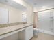 Bright bathroom with granite countertops, white cabinets, and a pristine shower with tile surround at 440 Patricia Alford Dr, Haines City, FL 33844