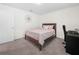 Comfortable bedroom with a cozy bed, a decorative mirror on the wall, and a functional workspace at 440 Patricia Alford Dr, Haines City, FL 33844