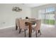 Inviting dining room with a rustic wooden table and elegant upholstered chairs, bathed in natural light at 440 Patricia Alford Dr, Haines City, FL 33844