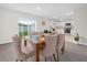 Cozy dining area features a wooden table with upholstered chairs and a view of the modern kitchen at 440 Patricia Alford Dr, Haines City, FL 33844