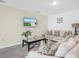 Well-decorated living room features neutral walls, plush carpeting, comfortable sofas, and modern decor at 440 Patricia Alford Dr, Haines City, FL 33844