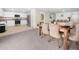 Open layout with dining area, view of living room, and modern kitchen with stainless steel appliances at 440 Patricia Alford Dr, Haines City, FL 33844