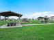 Community playground features shaded picnic tables, swings and a slide at 440 Patricia Alford Dr, Haines City, FL 33844